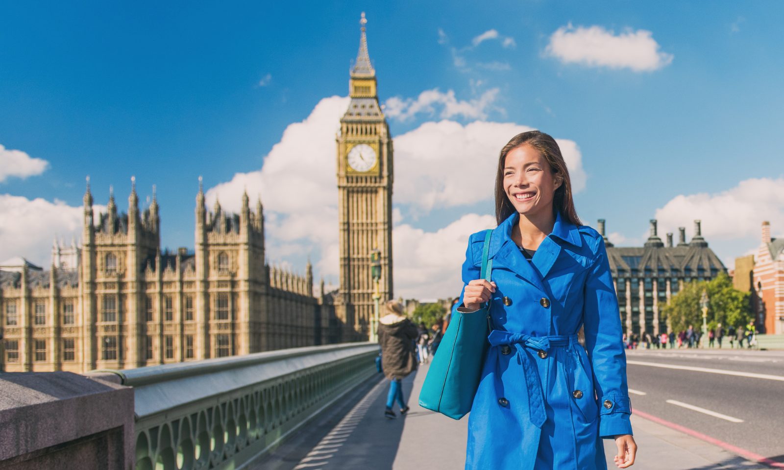 a woman in a blue coat on Westminster Bridge